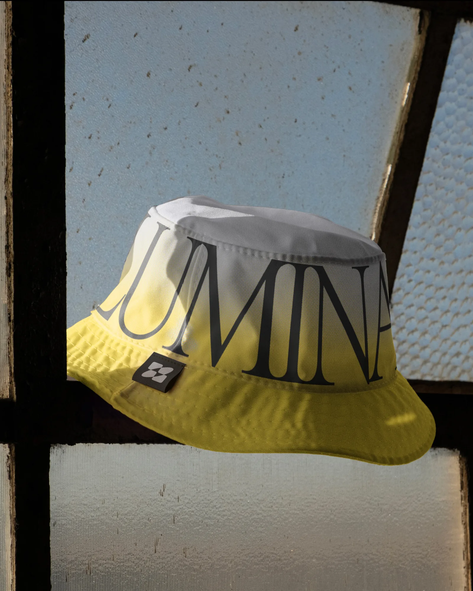 Yellow bucket hat carrying the Luminar wordmark