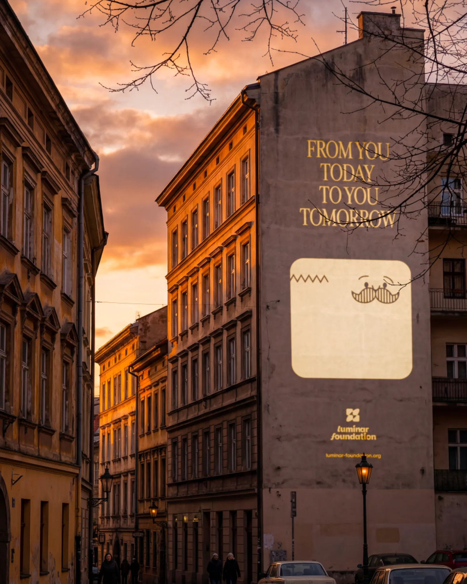 Building-side mural at dusk reading From you today. To you tomorrow.