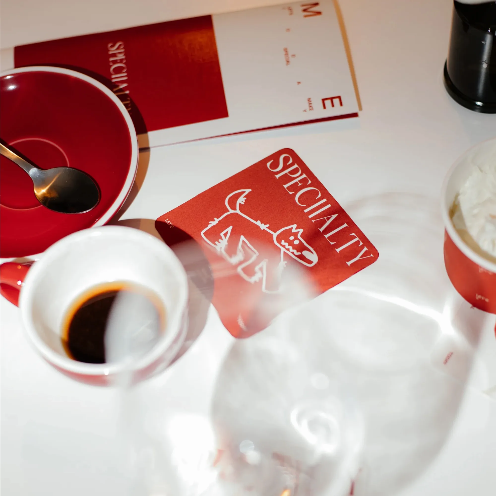 Coasters and cards on a table with coffee