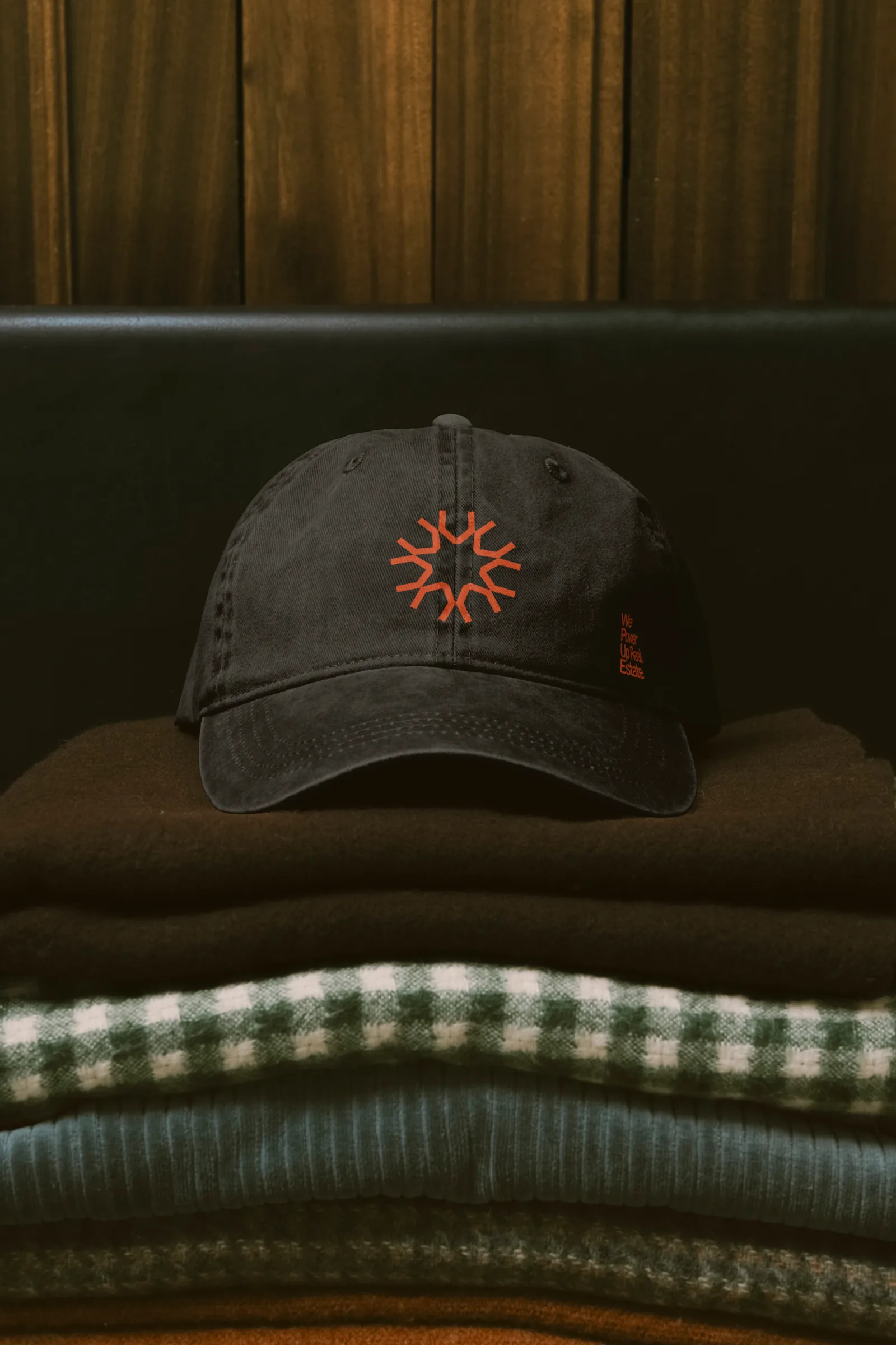 A branded cap on folded clothing